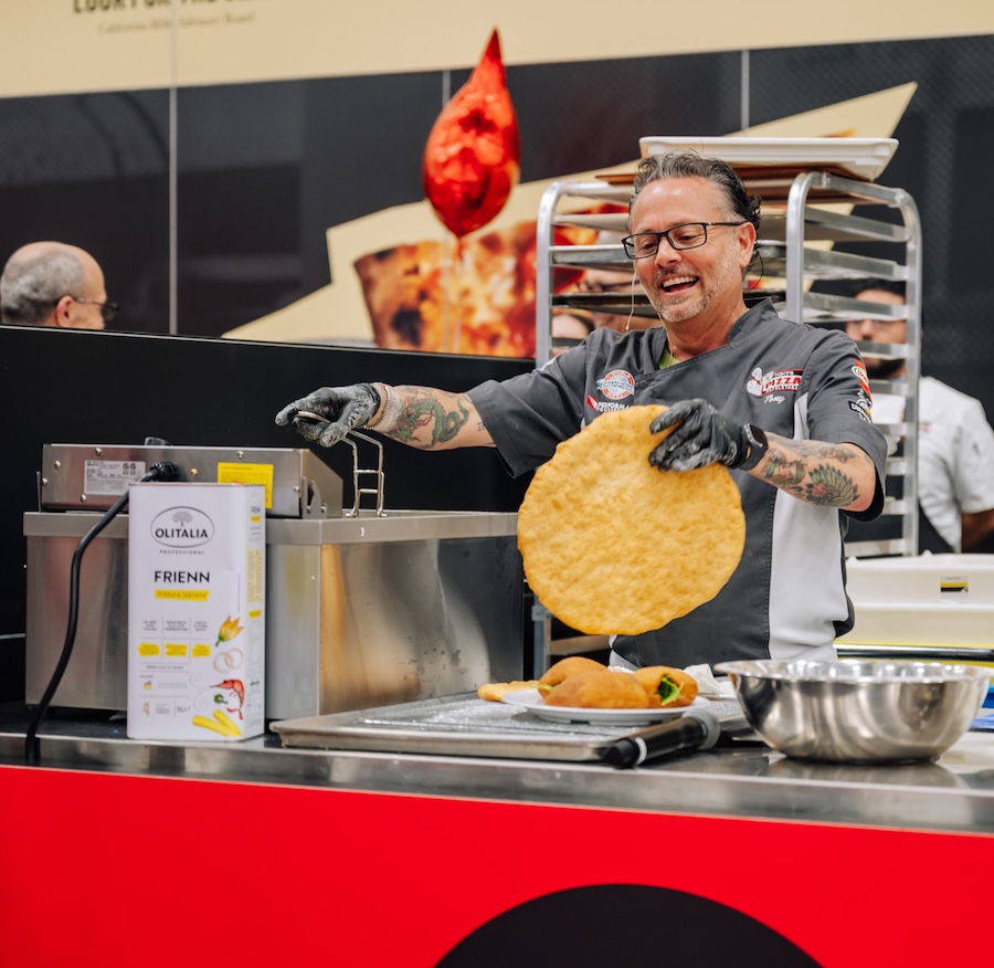 Pizza Master Tony Gemignani frying a Montanara pizza during a demonstration at Pizza Expo 2025 in Las Vegas.