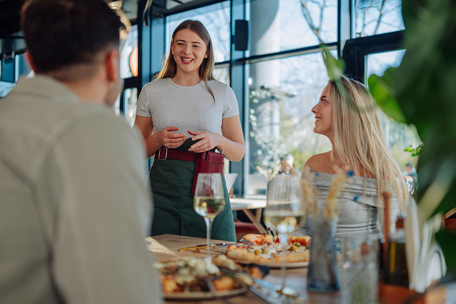 Wait staff takes orders from restaurant customers.